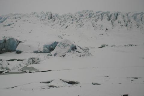 2003 Jeep TJ - A vast, snow-covered glacier landscape under an overcast sky, with visible ice formations and frozen water.