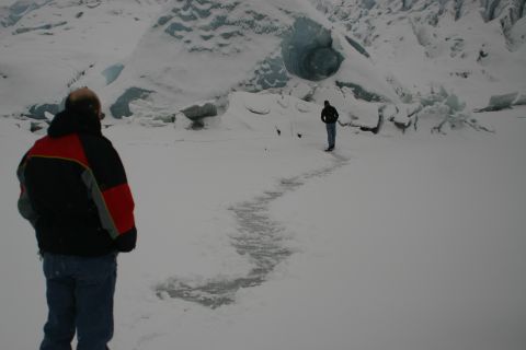 2003 Jeep TJ - Two individuals stand on a frozen landscape, with a large glacier visible in the background.