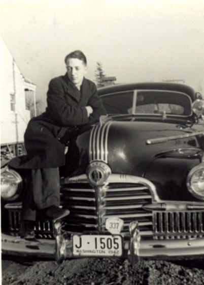 1976 Ford F-150 - A man poses with a vintage car, its license plate clearly indicating it is from Washington in 1942.