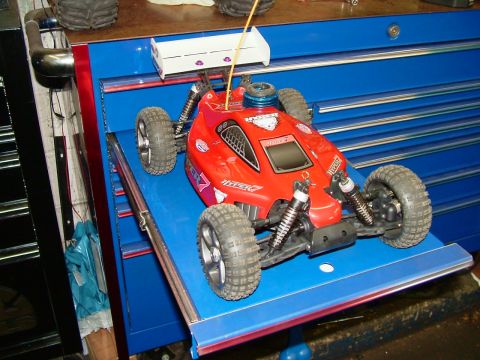 1994 Ford Bronco - A red remote control car sits on a blue surface, likely a toolbox drawer.