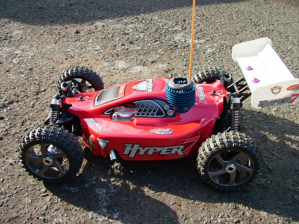 Red remote control car with white spoiler and blue engine, labeled 'Hyper 7'