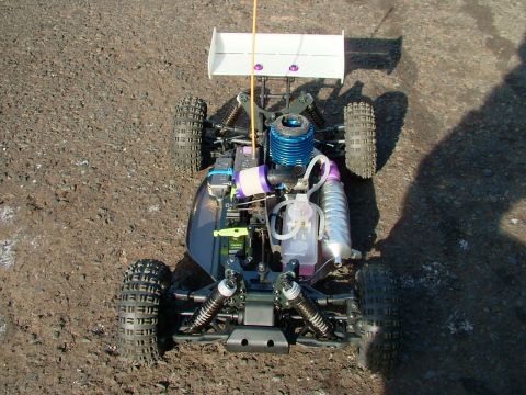 1994 Ford Bronco - Radio-controlled nitro buggy with a prominent blue engine and large rear spoiler.