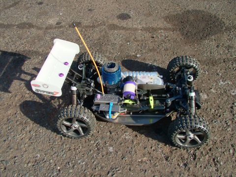 1994 Ford Bronco - This is a remote control car with a visible engine and spoiler. The text 'HYPER 7' is visible on the spoiler.