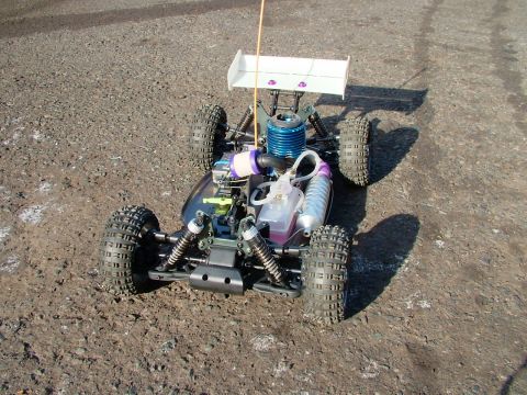 1994 Ford Bronco - This radio-controlled nitro buggy features a prominent blue engine and a white rear spoiler.
