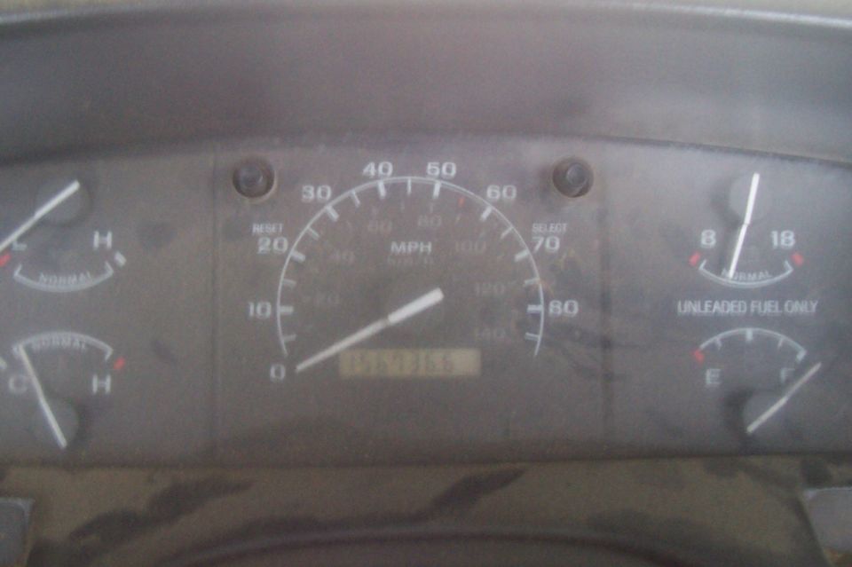 Dashboard gauges with speedometer, fuel gauge, and temperature gauges. Odometer reads 156735