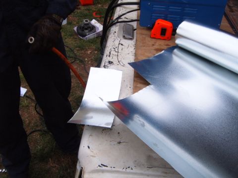 1988 Ford Bronco - Sheet metal is being cut on the bed of a truck, with tools and a differential visible in the background.