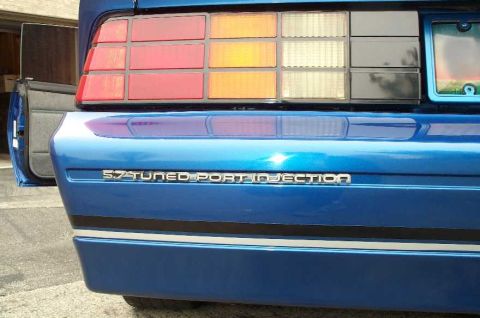 1990 Chevrolet Camaro - Rear view of a blue 1990 Chevrolet Camaro, the "5.7 TUNED PORT INJECTION" badging and distinctive taillights.