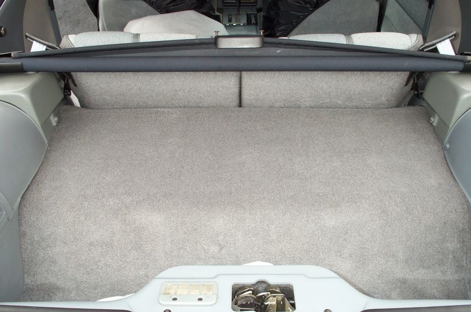 1990 Chevrolet Camaro trunk interior with grey carpet and cargo cover