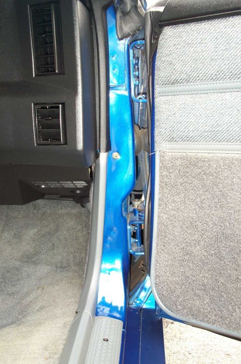 1990 Chevrolet Camaro - The interior of a car, focusing on the door jamb and dashboard with air vents.