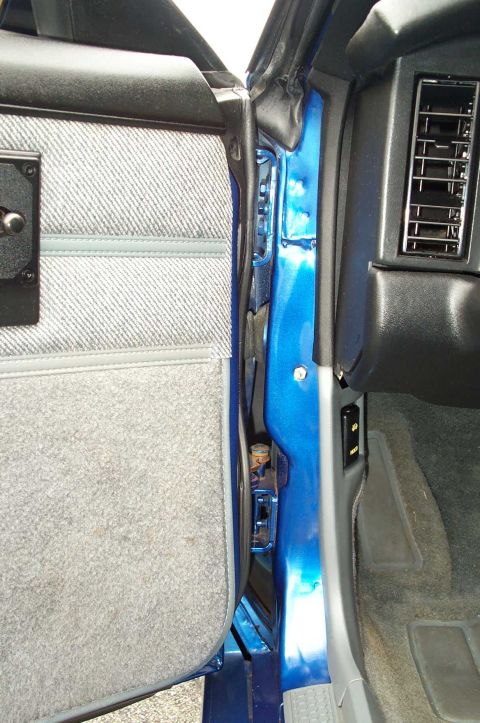 1990 Chevrolet Camaro - The interior door jamb and air vent of a blue 1990 Chevrolet Camaro are visible.