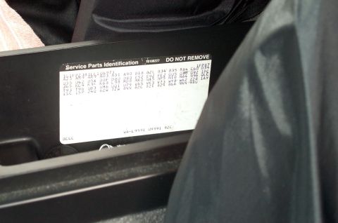 1990 Chevrolet Camaro - A close-up view of a service parts identification sticker found inside a vehicle.