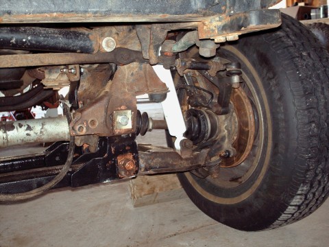 1977 Ford F-150 - Close-up view of the front suspension and wheel assembly on a 1977 Ford F-150 truck.