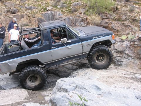 1990 Ford Bronco - Modified 1990 Ford Bronco tackling a challenging off-road course.