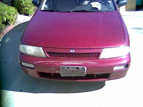 2000 Mercury Grand Marquis - Front view of a red sedan, likely a Nissan Altima, showing damage to the front bumper.