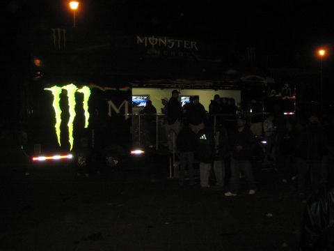 Monster Energy display trailer lit with logo at a nighttime event