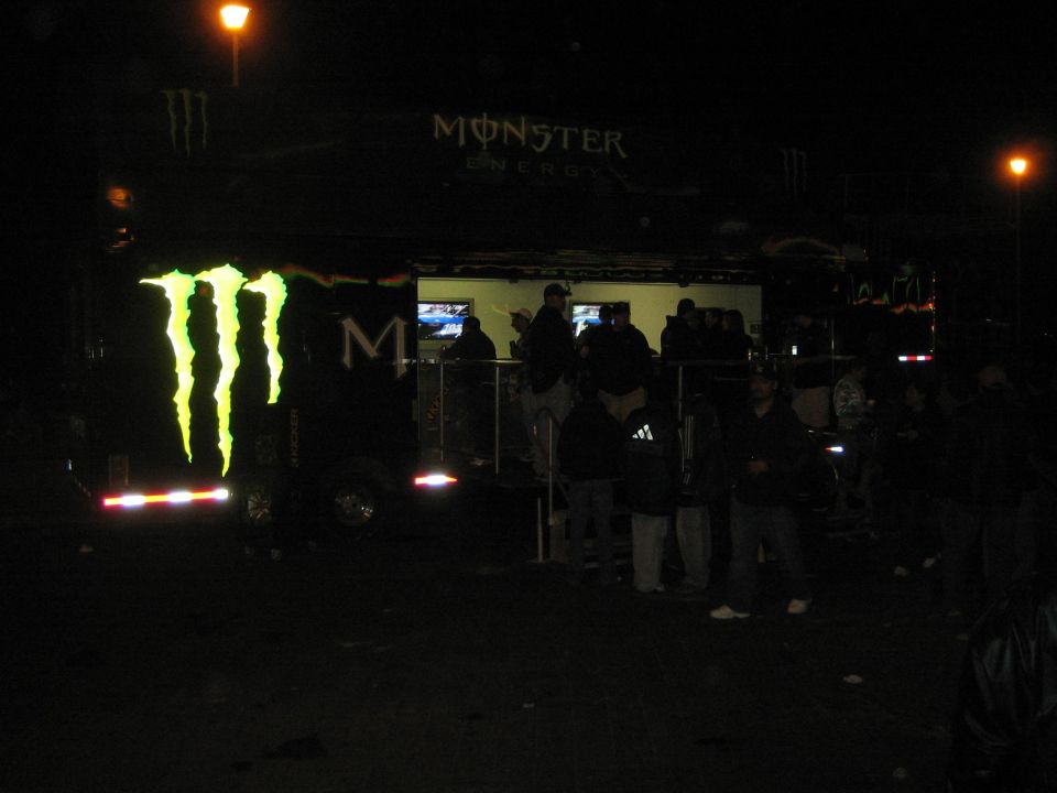 Monster Energy display trailer lit with logo at a nighttime event