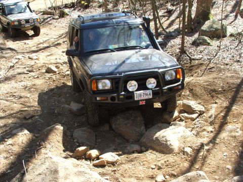 1996 Ford Bronco - Two Land Rover Discovery SUVs tackle a challenging rocky off-road course.