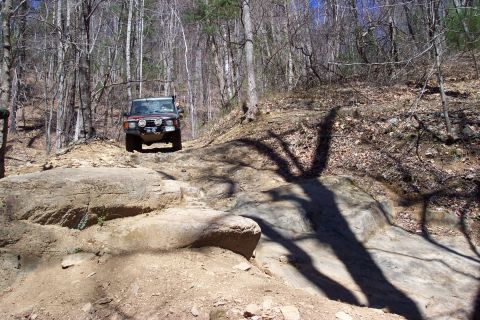 1987 Ford Bronco - Steve in one of the Landrovers preparing to punish some rocks.
