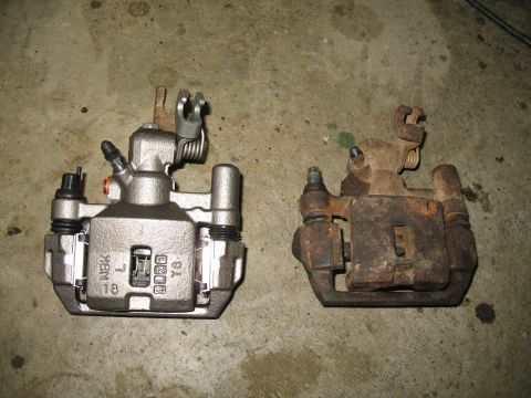 1996 Ford Probe - Comparison of a new brake caliper next to a heavily rusted old one.