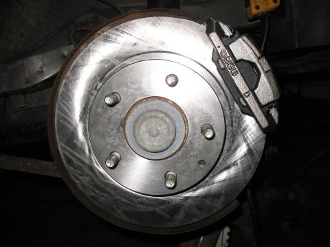 1996 Ford Probe - Close-up of a vehicle's brake rotor and caliper, which has 'MK60 D' visible on its surface.