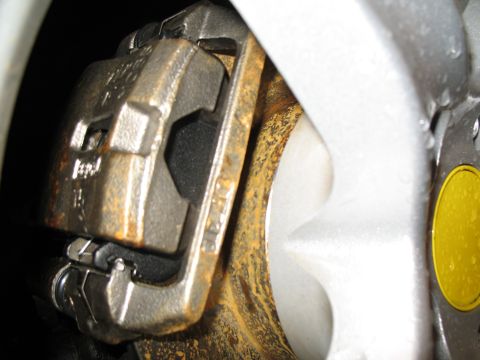 1996 Ford Probe - A close-up view of a vehicle's brake caliper and rotor, showing signs of rust.