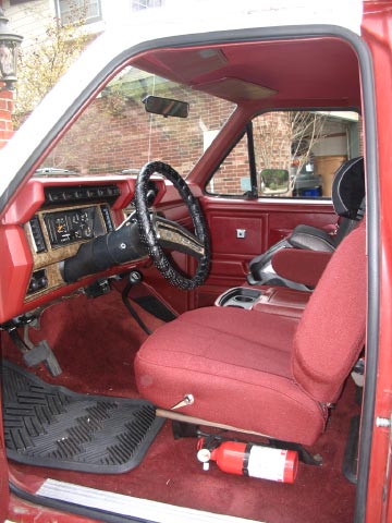1986 Ford Bronco - Interior view of a 1986 Ford Bronco, showing the driver's side seat, dashboard, and steering wheel.