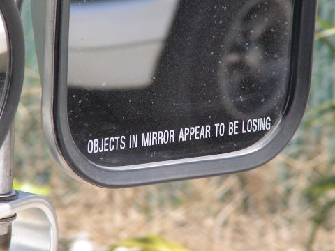1993 Ford C-350 (Centurion Conversions) - A towing mirror displays the common warning text, indicating objects behind are closer than they appear.
