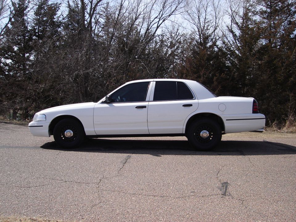 Side view of a white 2000 Ford Crown Victoria with tinted windows