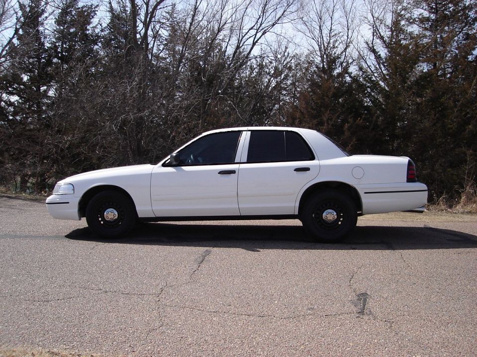 Side view of white 2000 Ford Crown Victoria with tinted windows