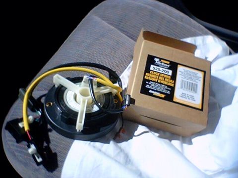 1994 Ford Bronco - Clock spring part and its packaging are shown, with text on the box indicating part number 525-200.