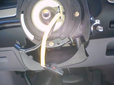 1994 Ford Bronco - Close-up of a vehicle's clock spring assembly, showing wiring and connectors.