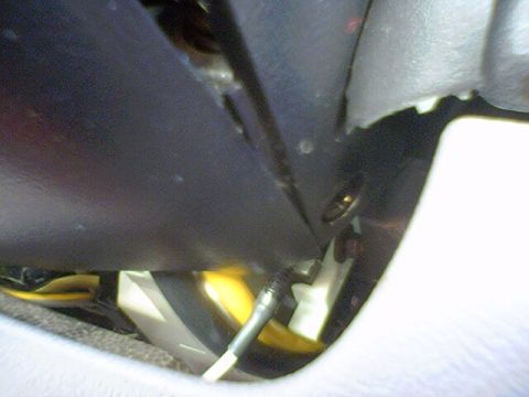 1994 Ford Bronco - A close-up view of the interior wiring and plastic trim of a vehicle, with a watermark indicating the source.