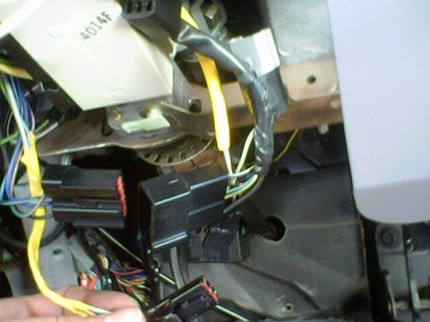 1994 Ford Bronco - Detail of a vehicle's interior wiring harness, showing connectors and various colored wires.