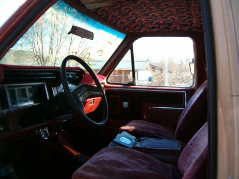 1985 Ford Bronco - View from inside a vehicle, looking towards the passenger side and out the windows at a rural landscape.