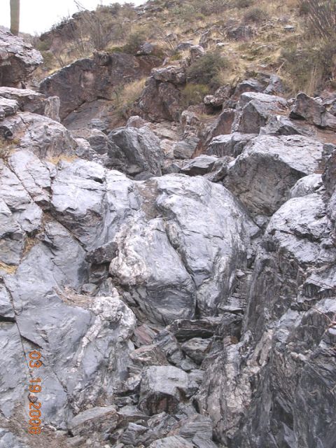 1994 Ford Bronco - A rocky hillside with sparse vegetation is visible, marked with a timestamp.