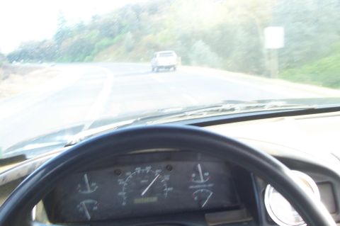 1994 Ford F-150 - Driving down a road with another vehicle in front, seen from the driver's perspective.