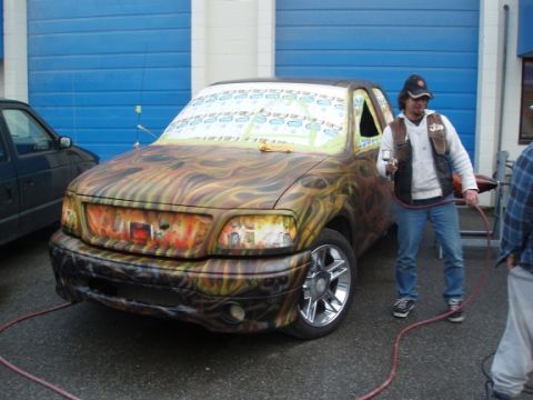 1985 Ford Bronco II - Custom painted pickup truck with flame graphics and a modified grille.