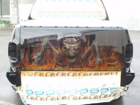 1985 Ford Bronco II - Tailgate airbrushed with a skull and flames, and covered with ranch dressing packets.