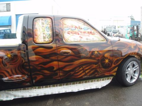 1985 Ford Bronco II - This custom pickup truck features a flame airbrush design and "TOTAL CONTROL" text on the windows.