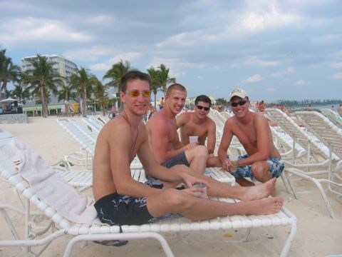 1989 Ford Bronco - A group of friends enjoy a sunny day at the beach, lounging on chairs under a cloudy sky.