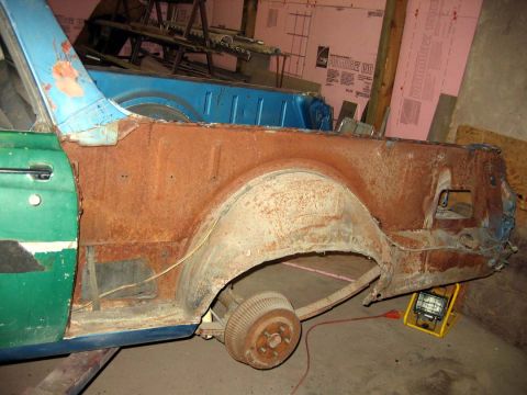 1971 Ford Ranchero - This 1971 Ford Ranchero shows extensive rust damage to its quarter panel and wheel well, indicating a need for significant repair.