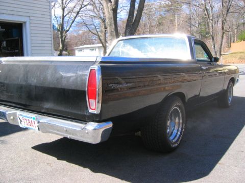 1968 Ford Ranchero - The rear of a black 1968 Ford Ranchero pickup truck is shown parked outdoors on a sunny day.