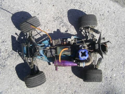 1985 Ford Bronco - This remote control car features a nitro engine and is shown from a top-down perspective on a concrete surface.