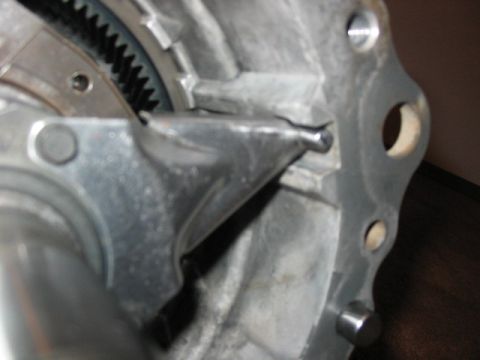 1995 Ford Bronco - Close-up of a damaged metal component, possibly from a transmission or transfer case, showing gears and bent metal.