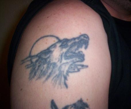 1970 Mercury Cougar - A tattoo of a wolf's head is visible on a person's upper arm.