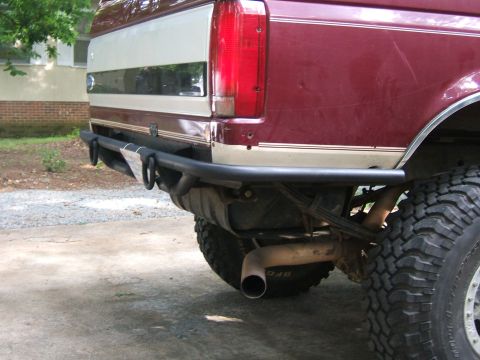 1993 Ford Bronco - Rear view of a 1993 Ford Bronco, showing its aftermarket bumper and off-road tire.