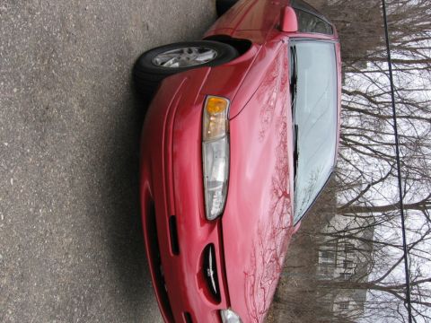 1995 Ford Thunderbird - Front quarter view of a red car. The styling cues, particularly the grille and headlights, are consistent with a mid-1990s model.