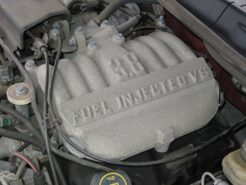 Engine intake manifold with '3.8L FUEL INJECTED V6' cast into it
