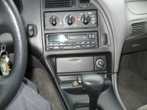 1995 Ford Thunderbird - Interior view of a 1995 Ford Thunderbird, focusing on the dashboard and center console.