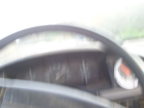 1994 Ford F-150 - Interior view of a vehicle's dashboard, showing blurry gauges and a steering wheel.